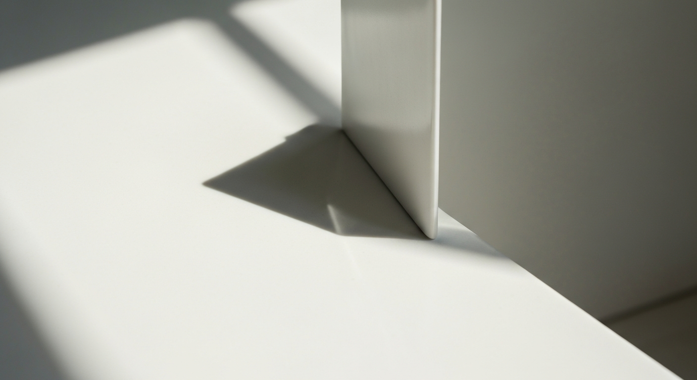 Clean white surface with single small object, sharp natural light from left, precise shadow lines, Monocle magazine editorial