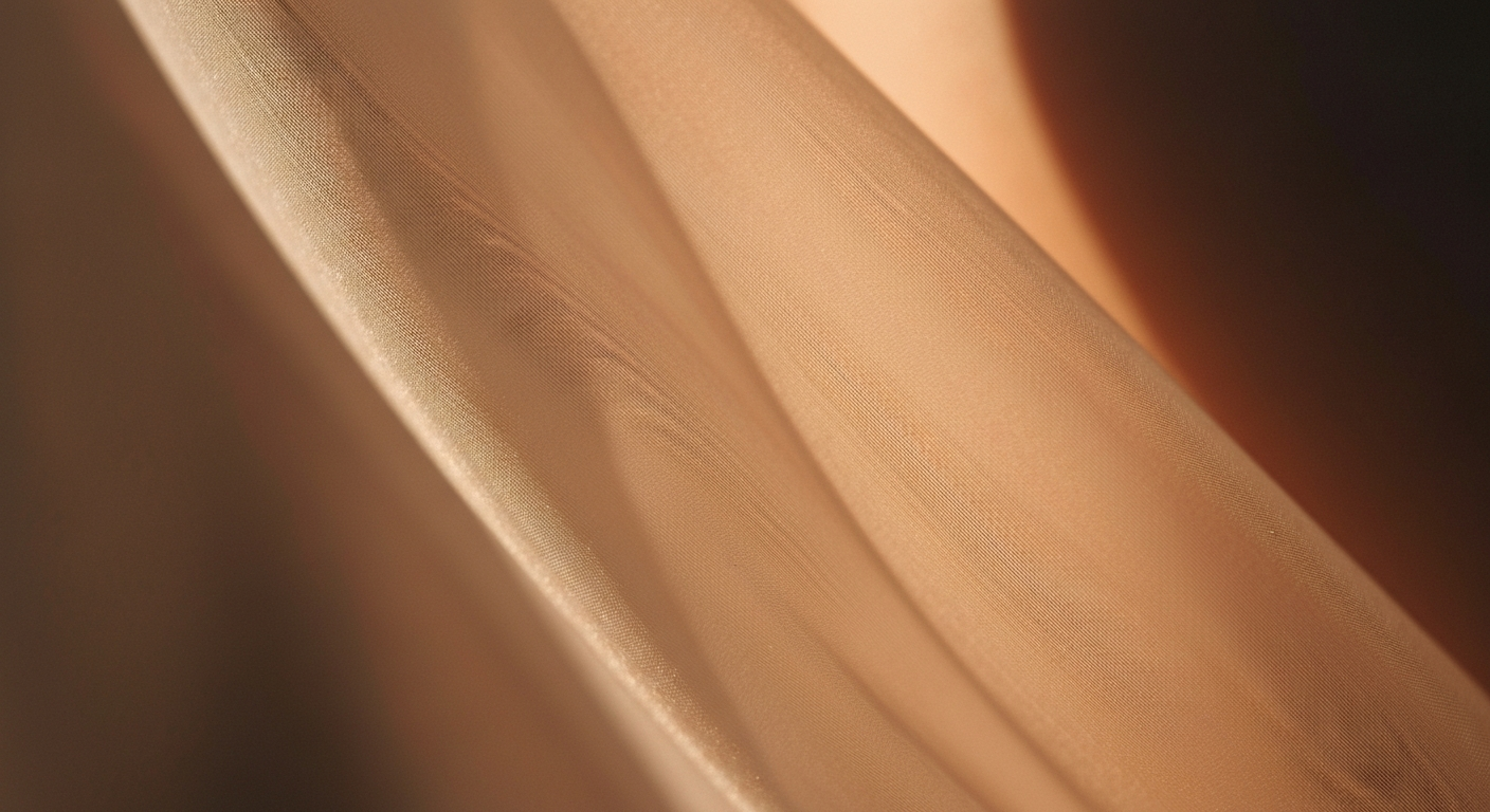 Detail of translucent fabric panel against warm skin tone, diffuse natural light, no branding, Cereal magazine aesthetic
