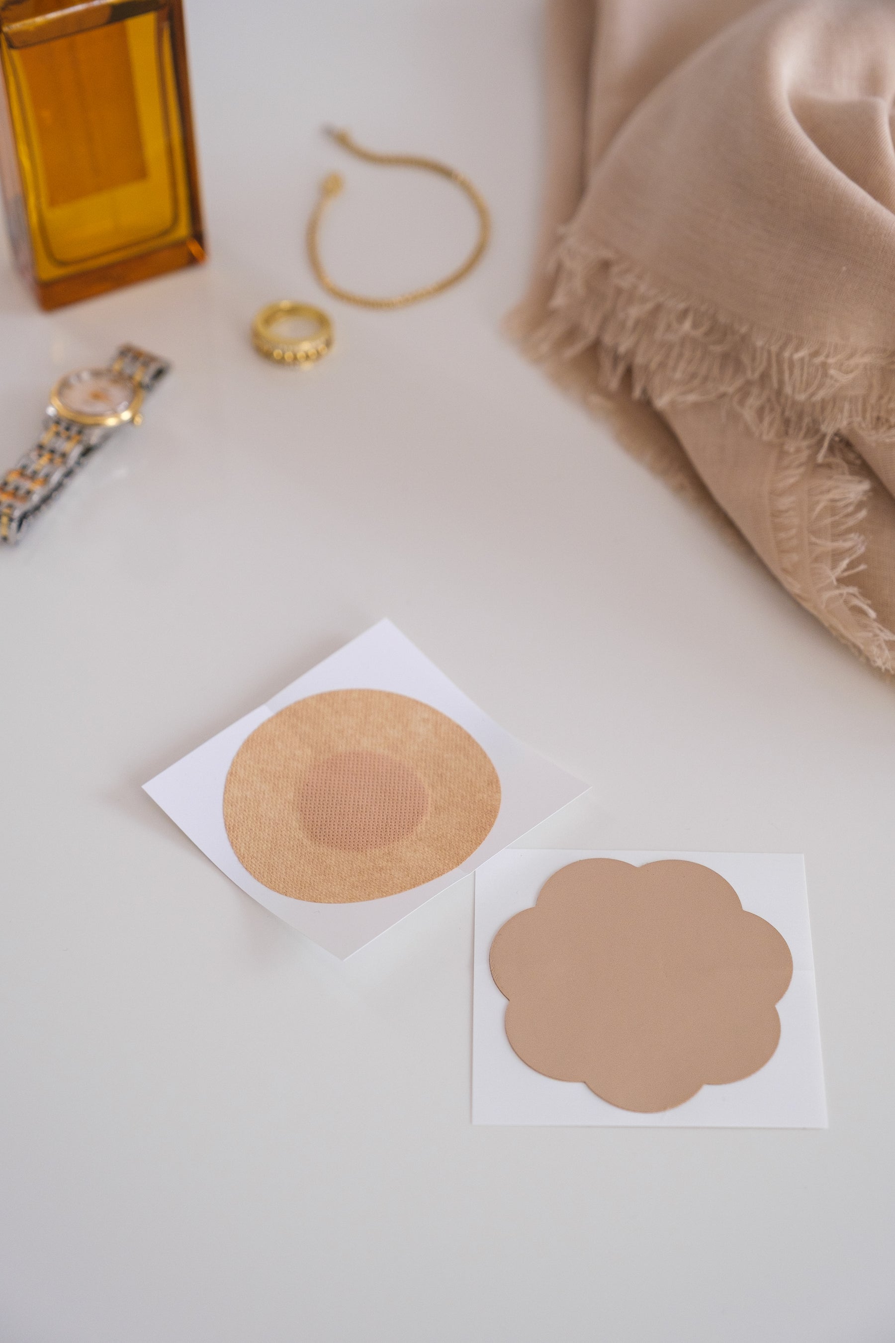 Silicone covers flat lay with watch bracelet perfume on white