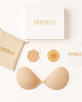 The Skindelle Bridal Kit contents: adhesive bra, silicone covers, paper covers, suede pouch, and branded box